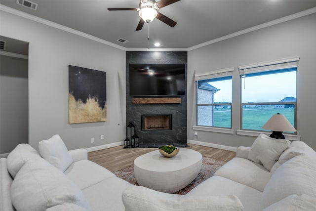 1301 Wilderness Ln, Forney, TX 75126 - living room with wood finished floors, ceiling fan, ornamental molding, and a premium fireplace