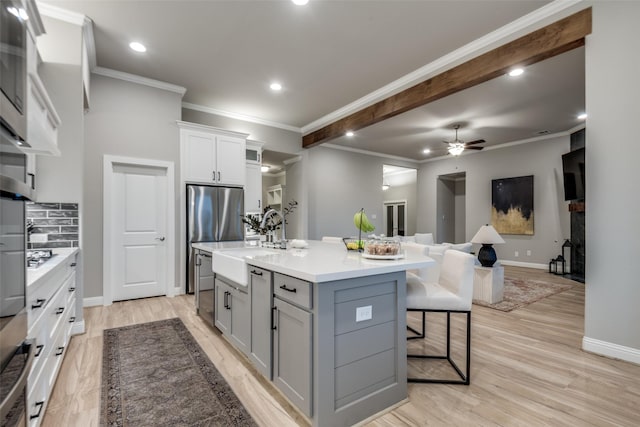 1301 Wilderness Ln, Forney, TX 75126 - kitchen featuring gray cabinetry, a ceiling fan, tasteful backsplash, light countertops, and open floor plan