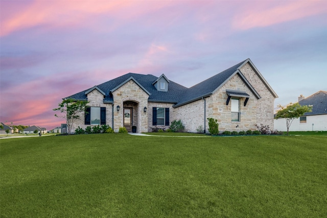 1301 Wilderness Ln, Forney, TX 75126 - french country inspired facade featuring stone siding, a front yard, and a shingled roof