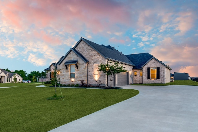 1301 Wilderness Ln, Forney, TX 75126 - french country inspired facade featuring concrete driveway, a yard, an attached garage, stone siding, and brick siding