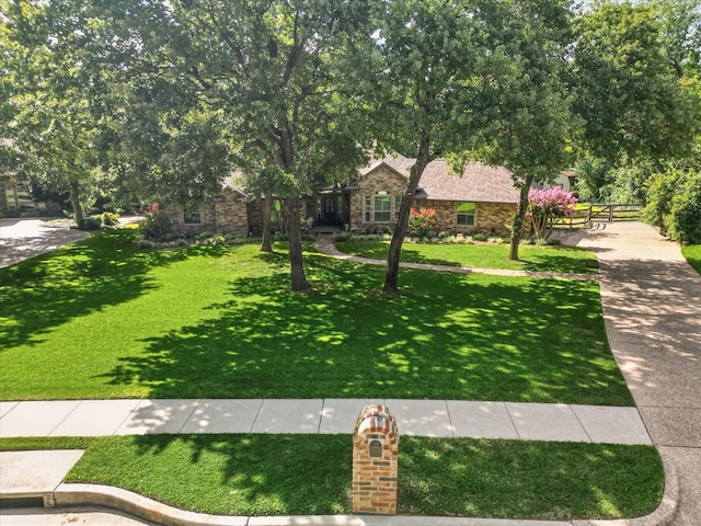 1812 Winding Creek Blvd, Flower Mound, TX 75022 - obstructed view of property with stone siding and a front lawn