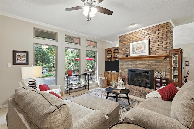 1812 Winding Creek Blvd, Flower Mound, TX 75022 - tiled living area featuring crown molding, ceiling fan, a textured ceiling, and a fireplace
