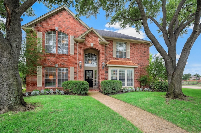 901 Brown Trl, Coppell, TX 75019 - traditional-style home featuring brick siding and a front lawn