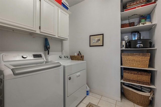 901 Brown Trl, Coppell, TX 75019 - laundry room featuring separate washer and dryer, cabinet space, and light tile patterned floors