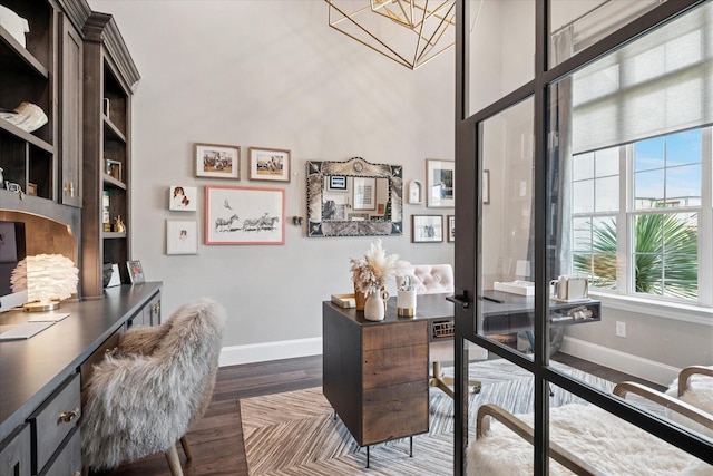 15111 Spider Lily Rd, Frisco, TX 75035 - office area featuring dark wood finished floors, a chandelier, and a high ceiling
