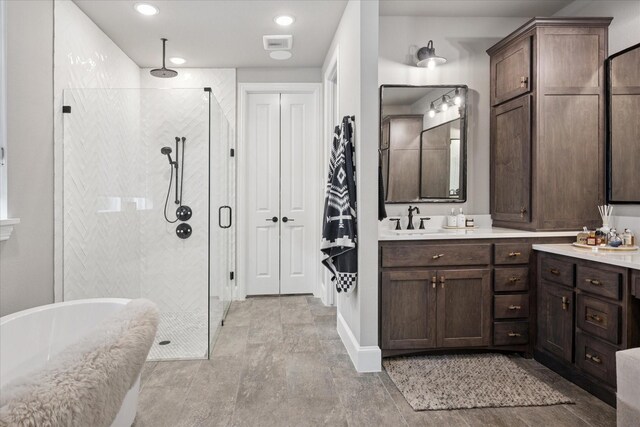 15111 Spider Lily Rd, Frisco, TX 75035 - full bathroom with a stall shower, a freestanding bath, vanity, and recessed lighting