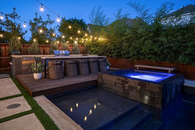 15111 Spider Lily Rd, Frisco, TX 75035 - view of pool with an outdoor hot tub, a fenced backyard, a wooden deck, an outdoor kitchen, and a patio