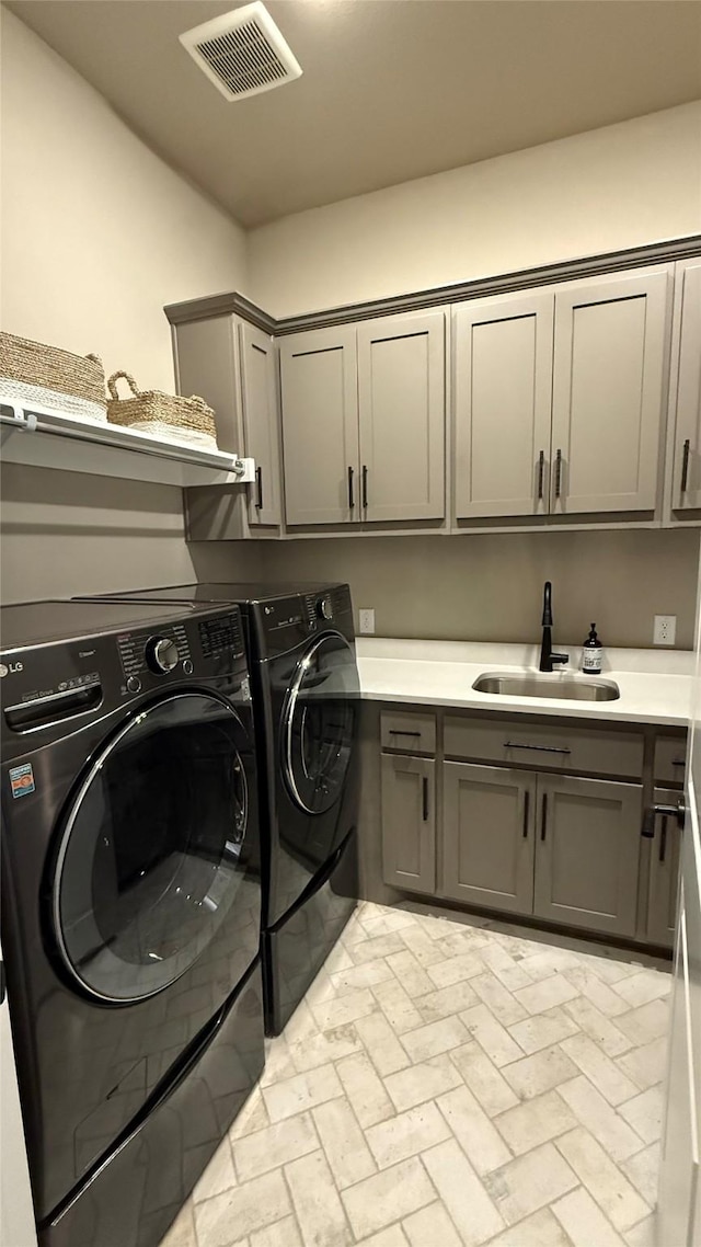 15111 Spider Lily Rd, Frisco, TX 75035 - laundry room featuring cabinet space, separate washer and dryer, and brick patterned floors