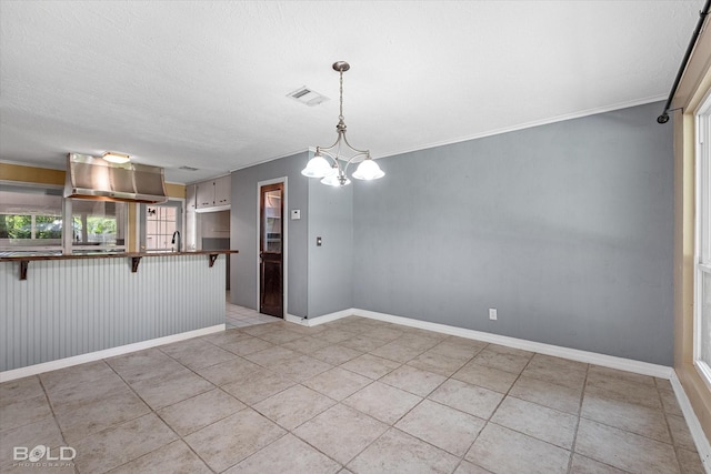 858 River Rd, Shreveport, LA 71105 - unfurnished dining area featuring a chandelier, light tile patterned floors, and ornamental molding