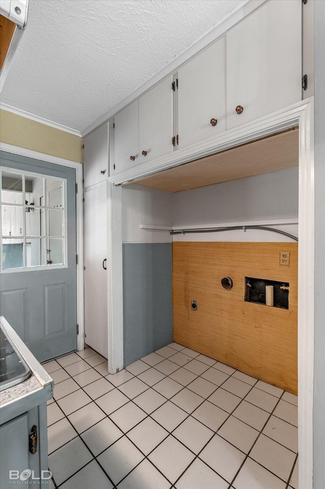 858 River Rd, Shreveport, LA 71105 - laundry area with cabinet space, a textured ceiling, light tile patterned floors, crown molding, and washer hookup