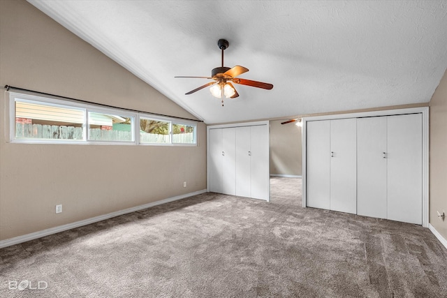 858 River Rd, Shreveport, LA 71105 - unfurnished bedroom featuring vaulted ceiling, carpet floors, two closets, a textured ceiling, and ceiling fan