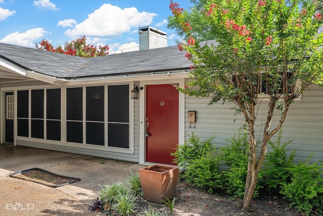 858 River Rd, Shreveport, LA 71105 - doorway to property with a shingled roof, a chimney, and a patio