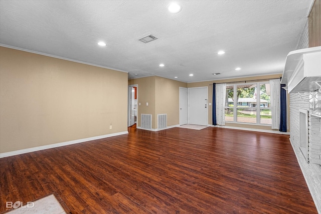 858 River Rd, Shreveport, LA 71105 - unfurnished living room with wood finished floors, recessed lighting, a brick fireplace, crown molding, and a textured ceiling