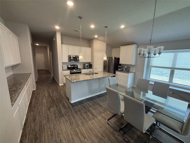 8932 Lantana Meadow Dr, Fort Worth, TX 76131 - kitchen featuring appliances with stainless steel finishes, a chandelier, dark wood-style flooring, a center island with sink, and white cabinetry