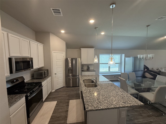 8932 Lantana Meadow Dr, Fort Worth, TX 76131 - kitchen featuring stainless steel appliances, a center island with sink, a chandelier, white cabinets, and dark stone counters