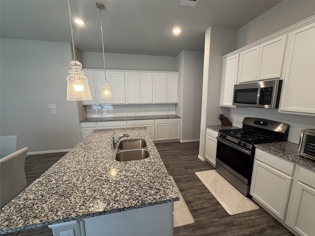 8932 Lantana Meadow Dr, Fort Worth, TX 76131 - kitchen featuring stainless steel appliances, decorative backsplash, a kitchen island with sink, white cabinetry, and recessed lighting