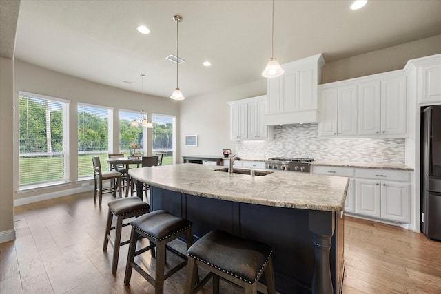 4618 Sky Harbor Dr, Rockwall, TX 75087 - kitchen featuring decorative backsplash, light wood finished floors, recessed lighting, and white cabinets