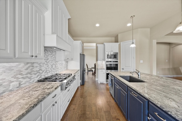 4618 Sky Harbor Dr, Rockwall, TX 75087 - kitchen featuring blue cabinetry, appliances with stainless steel finishes, white cabinets, wood finished floors, and recessed lighting