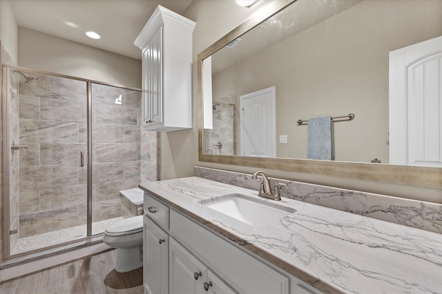 4618 Sky Harbor Dr, Rockwall, TX 75087 - bathroom with vanity, a stall shower, wood finished floors, and recessed lighting