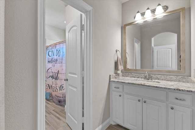 4618 Sky Harbor Dr, Rockwall, TX 75087 - bathroom featuring vanity, wood finished floors, and a textured wall