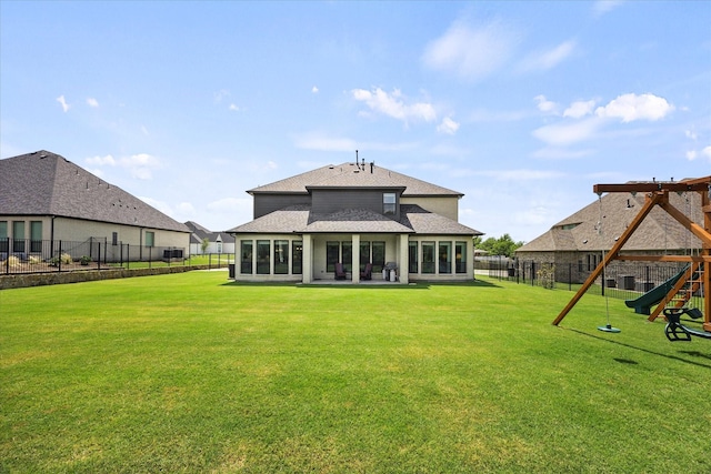 4618 Sky Harbor Dr, Rockwall, TX 75087 - back of house featuring a fenced backyard, a shingled roof, and a playground