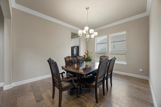 4618 Sky Harbor Dr, Rockwall, TX 75087 - dining space with a chandelier, crown molding, and wood finished floors