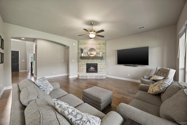 4618 Sky Harbor Dr, Rockwall, TX 75087 - living area with arched walkways, ceiling fan, wood finished floors, and a fireplace