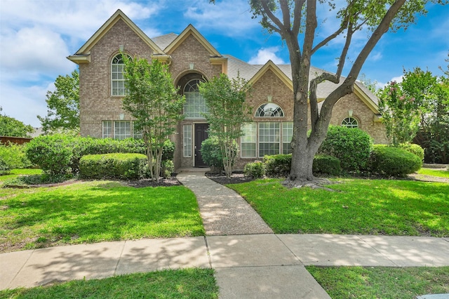 8504 Beatton Ct, Plano, TX 75025 - traditional-style home featuring brick siding and a front lawn