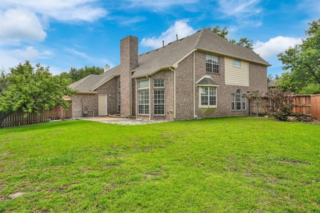 8504 Beatton Ct, Plano, TX 75025 - back of property featuring a fenced backyard, brick siding, a patio, and a chimney
