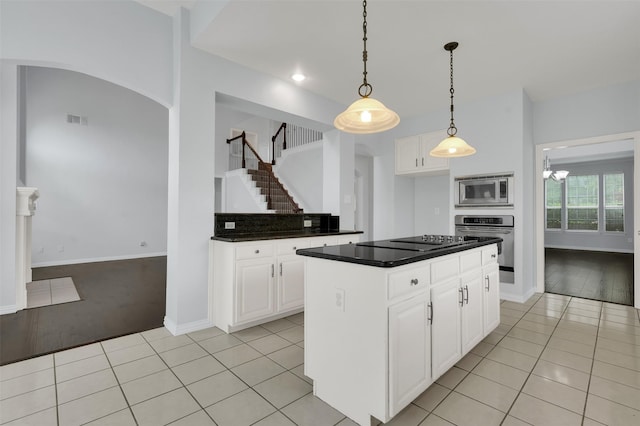 8504 Beatton Ct, Plano, TX 75025 - kitchen featuring appliances with stainless steel finishes, dark countertops, light tile patterned floors, and white cabinetry