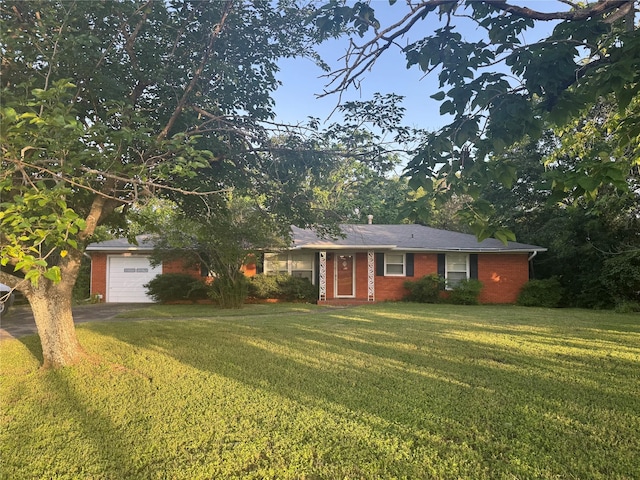 311 E Newland Dr, Robinson, TX 76706 - view of front of home featuring brick siding, a front lawn, driveway, and a garage