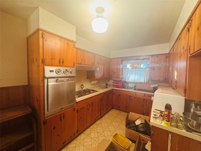 311 E Newland Dr, Robinson, TX 76706 - kitchen featuring stainless steel appliances, under cabinet range hood, light countertops, and wainscoting