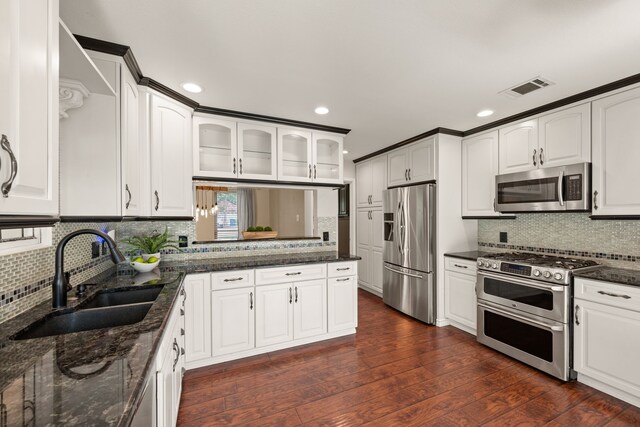 4147 Woodside Knl, Grapevine, TX 76051 - kitchen featuring stainless steel appliances, tasteful backsplash, glass insert cabinets, and recessed lighting