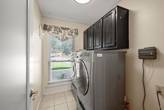 4147 Woodside Knl, Grapevine, TX 76051 - laundry room featuring washing machine and clothes dryer, cabinet space, and light tile patterned floors