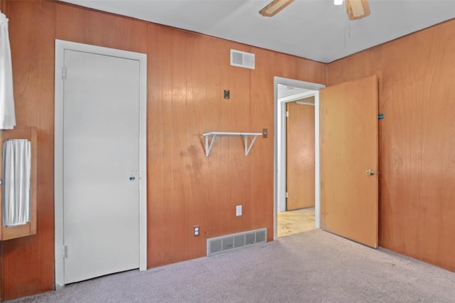 10230 Kilkenny Pl, Dallas, TX 75228 - unfurnished bedroom featuring carpet flooring, wood walls, and ceiling fan