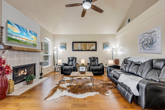 7909 Quest Ct, Frisco, TX 75035 - living room with vaulted ceiling, a ceiling fan, hardwood / wood-style flooring, and a fireplace