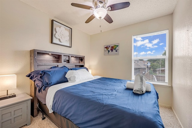 7909 Quest Ct, Frisco, TX 75035 - bedroom featuring light carpet, ceiling fan, and a textured wall