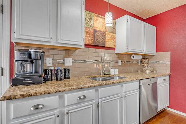 7909 Quest Ct, Frisco, TX 75035 - kitchen featuring dishwasher, a textured wall, tasteful backsplash, white cabinets, and light stone counters