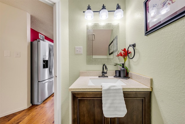 7909 Quest Ct, Frisco, TX 75035 - bathroom with vanity and wood finished floors