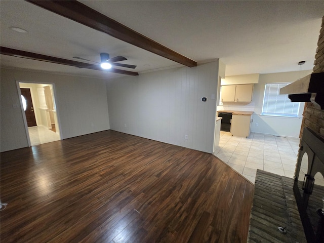 5323 Dazzle Dr, Dallas, TX 75232 - unfurnished living room featuring a fireplace with raised hearth, beamed ceiling, light wood-style flooring, and a ceiling fan