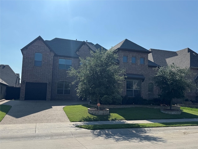 3323 Royal Ridge Dr, Rockwall, TX 75087 - view of front facade with brick siding, driveway, a front yard, and an attached garage