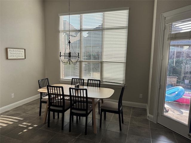 3323 Royal Ridge Dr, Rockwall, TX 75087 - dining area with dark tile patterned flooring and baseboards