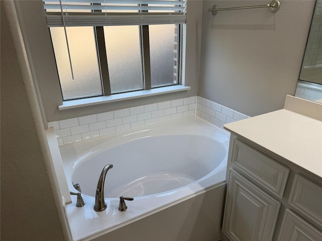 3323 Royal Ridge Dr, Rockwall, TX 75087 - bathroom with a garden tub, vanity, and a textured wall