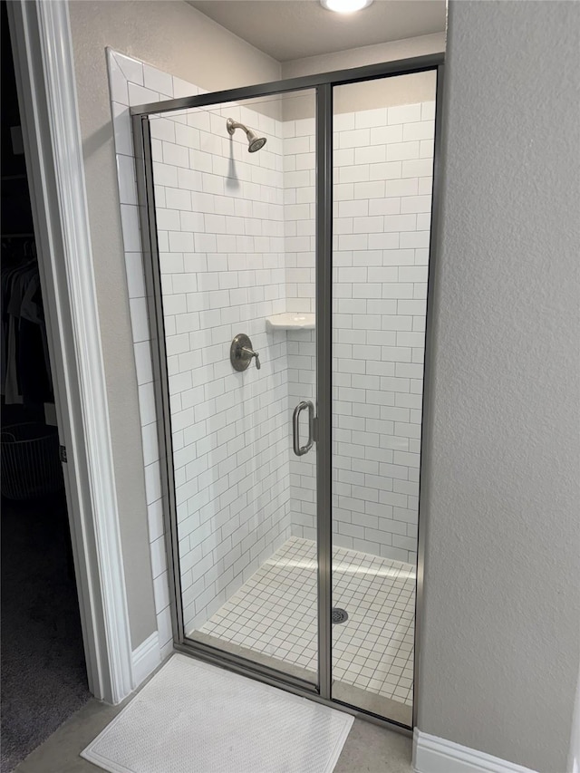 3323 Royal Ridge Dr, Rockwall, TX 75087 - bathroom with a shower stall, a walk in closet, and a textured wall