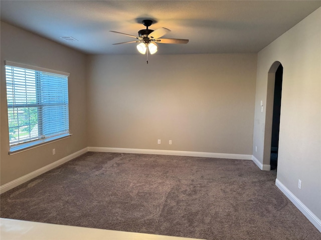 3323 Royal Ridge Dr, Rockwall, TX 75087 - empty room with arched walkways, a ceiling fan, and dark carpet