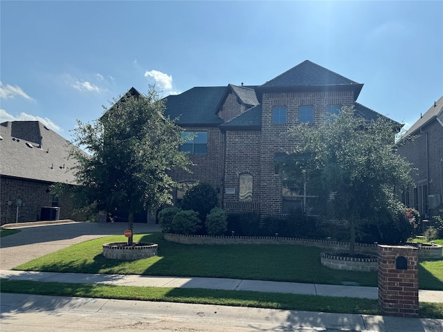 3323 Royal Ridge Dr, Rockwall, TX 75087 - traditional-style house featuring brick siding, a front lawn, and roof with shingles