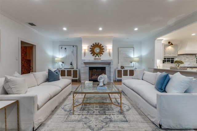 7402 Centenary Ave, Dallas, TX 75225 - living room featuring a glass covered fireplace, recessed lighting, crown molding, and light wood-style floors