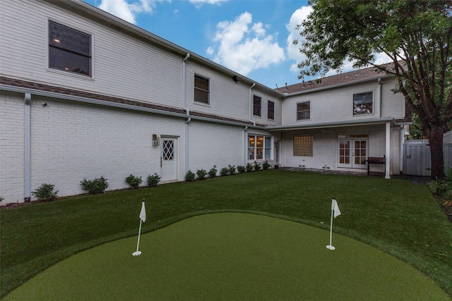 7402 Centenary Ave, Dallas, TX 75225 - rear view of property featuring a putting green, brick siding, and french doors