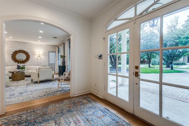 7402 Centenary Ave, Dallas, TX 75225 - doorway to outside with wood finished floors, ornamental molding, plenty of natural light, arched walkways, and wallpapered walls