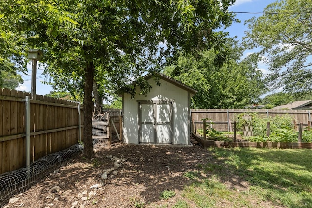 7516 Deaver Dr, North Richland Hills, TX 76180 - view of shed with a garden and a fenced backyard